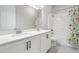 Well-lit bathroom featuring double sinks, a shower/tub, and modern fixtures at 16701 Vibrato Ln, Land O Lakes, FL 34638