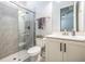 Bright bathroom with glass-enclosed shower, white vanity, and modern fixtures at 16701 Vibrato Ln, Land O Lakes, FL 34638