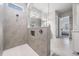Modern bathroom featuring a tiled shower with glass partition and neutral color palette at 16701 Vibrato Ln, Land O Lakes, FL 34638