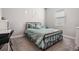 Comfortable bedroom with carpet, natural light, metal bed frame and light blue comforter at 16701 Vibrato Ln, Land O Lakes, FL 34638