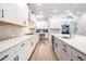 Bright, modern kitchen with white cabinets, stainless steel appliances and a stone tile backsplash at 16701 Vibrato Ln, Land O Lakes, FL 34638