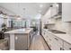 Spacious kitchen and breakfast area with stainless appliances, island seating, and access to living area at 16701 Vibrato Ln, Land O Lakes, FL 34638