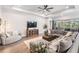 Bright living room with a large sectional sofa, stylish decor, and plenty of space for relaxation at 16701 Vibrato Ln, Land O Lakes, FL 34638