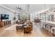 Spacious living room with wood floors, a modern ceiling fan, and large windows for ample light at 16701 Vibrato Ln, Land O Lakes, FL 34638