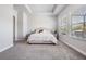 Serene main bedroom with tray ceiling, neutral decor, and bright windows at 16701 Vibrato Ln, Land O Lakes, FL 34638