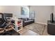 Well-lit office area featuring a gray couch, desk, and contemporary decor at 16701 Vibrato Ln, Land O Lakes, FL 34638