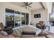 Relaxing covered patio with cozy seating, a ceiling fan, and outdoor television at 16701 Vibrato Ln, Land O Lakes, FL 34638