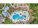 Aerial view of a uniquely shaped community pool and sundeck area with plenty of seating and shade at 16701 Vibrato Ln, Land O Lakes, FL 34638