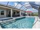 Beautiful screened-in pool and patio area with ample seating and outdoor cooking space at 16701 Vibrato Ln, Land O Lakes, FL 34638