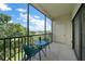 Screened balcony with seating area and serene views of the surrounding landscape at 700 Starkey Rd # 344, Largo, FL 33771