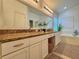 Beautiful bathroom featuring a double vanity, granite countertops, soaking tub, and ample storage at 19830 Ellendale Dr, Land O Lakes, FL 34638