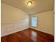 Empty bedroom with hardwood floors, wall trim, window, and neutral walls at 19830 Ellendale Dr, Land O Lakes, FL 34638