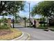 Gated community entrance with stone pillars and manicured landscaping, enhancing curb appeal at 19830 Ellendale Dr, Land O Lakes, FL 34638