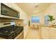 Well-equipped kitchen with sleek appliances, a gas range, light cabinets, and a connected dining area at 19830 Ellendale Dr, Land O Lakes, FL 34638