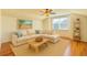 Comfortable living room with neutral sectional sofa, wood coffee table, and large window at 19830 Ellendale Dr, Land O Lakes, FL 34638