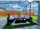 Relaxing screened-in patio with comfortable seating, a stylish rug, and a beautiful view of the backyard at 19830 Ellendale Dr, Land O Lakes, FL 34638