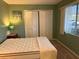 Cozy bedroom with double bed, closet, and window at 2060 Marilyn St # 124, Clearwater, FL 33765