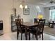 Bright dining area with a table and four chairs, adjacent to the living room at 2060 Marilyn St # 124, Clearwater, FL 33765