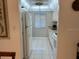 Kitchen features white cabinets, granite countertops, and a refrigerator at 2060 Marilyn St # 124, Clearwater, FL 33765