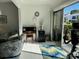 Bright sunroom with patio access, featuring comfortable seating and a workspace at 2060 Marilyn St # 124, Clearwater, FL 33765