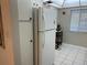 White refrigerator in kitchen with granite countertops and cabinets at 2060 Marilyn St # 124, Clearwater, FL 33765