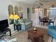 Spacious living room with seating area and view into dining area at 2060 Marilyn St # 124, Clearwater, FL 33765