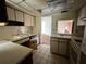 Kitchen features white cabinets, stove, and a pass-through window at 3754 Lake Joyce Dr, Land O Lakes, FL 34639