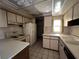Kitchen with white cabinets, appliances, and double sink at 3754 Lake Joyce Dr, Land O Lakes, FL 34639