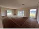 Bright living room with multiple windows and lake view at 3754 Lake Joyce Dr, Land O Lakes, FL 34639