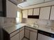 Kitchen with white cabinets, double sink, and a window at 3754 Lake Joyce Dr, Land O Lakes, FL 34639