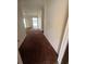 Long hallway with brown carpet leading to other rooms at 3754 Lake Joyce Dr, Land O Lakes, FL 34639