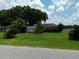 Ranch style home with large grassy yard and mature trees at 3754 Lake Joyce Dr, Land O Lakes, FL 34639