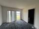 Bright bedroom with a view, sliding glass doors, and wall-to-wall carpeting at 3754 Lake Joyce Dr, Land O Lakes, FL 34639