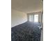 Spacious living room with wall-to-wall carpeting and access to a balcony at 3754 Lake Joyce Dr, Land O Lakes, FL 34639