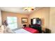 Guest bedroom with a comfortable bed, ceiling fan, and a well-lit space at 10254 Red Currant Ct, Riverview, FL 33578