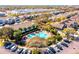 Overhead shot of a community pool and clubhouse surrounded by palm trees and well-manicured landscaping at 10254 Red Currant Ct, Riverview, FL 33578
