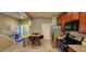 The kitchen features stainless steel appliances, wood cabinets, and a cozy breakfast nook with seating for four at 10254 Red Currant Ct, Riverview, FL 33578