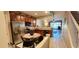 Modern kitchen with stainless steel appliances, granite countertops, and a view of the backyard through sliding glass doors at 10254 Red Currant Ct, Riverview, FL 33578