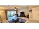 Bright living room with a ceiling fan, sliding glass doors to screened lanai, and natural light at 10254 Red Currant Ct, Riverview, FL 33578