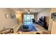 The well-lit living room features a ceiling fan and sliding glass doors to a screened-in patio and backyard at 10254 Red Currant Ct, Riverview, FL 33578