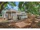 Backyard view of house with leafy trees and privacy fence at 1006 E Fern St, Tampa, FL 33604