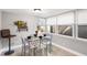Cozy dining area with glass table and four chairs, bathed in natural light at 1006 E Fern St, Tampa, FL 33604