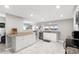 Modern kitchen with white cabinets, granite countertops, and stainless steel appliances at 1006 E Fern St, Tampa, FL 33604