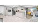 Stylish kitchen features white cabinets, granite counters, and stainless steel appliances at 1006 E Fern St, Tampa, FL 33604