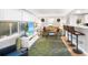 Relaxing living room featuring a sofa, TV, and sunroom access at 1006 E Fern St, Tampa, FL 33604