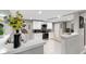 Modern kitchen with white cabinets, granite counters, and stainless steel appliances at 1006 E Fern St, Tampa, FL 33604