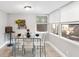 Bright dining area with glass table and four chairs, adjacent to sunroom at 1006 E Fern St, Tampa, FL 33604