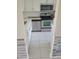 Modern kitchen with stainless steel appliances and white cabinets at 318 Windrush Blvd # 9, Indian Rocks Beach, FL 33785