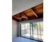 Living room with wood beamed ceiling, sliding doors to balcony at 318 Windrush Blvd # 9, Indian Rocks Beach, FL 33785