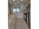 Bright kitchen with white cabinets, quartz countertops, and stainless steel appliances at 318 Windrush Blvd # 9, Indian Rocks Beach, FL 33785